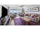 Bright living room featuring a comfortable couch, patterned rug, and sliding glass doors to balcony with scenic views at 4410 Fairways Blvd # 605, Bradenton, FL 34209