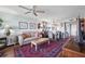 Living room featuring ceiling fan, hardwood floors, stylish rug and pass through to the dining room at 4410 Fairways Blvd # 605, Bradenton, FL 34209