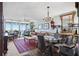 Inviting open-concept living and dining area with chandelier, glass table, large windows, and balcony access at 4410 Fairways Blvd # 605, Bradenton, FL 34209