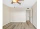 Bedroom featuring wood floors, a ceiling fan, and a closet with white doors at 4885 1St Ne St # 308, St Petersburg, FL 33703