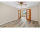 Bedroom with wood-look floors and paneled doors leading to the Florida room at 4885 1St Ne St # 308, St Petersburg, FL 33703