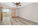 Bedroom featuring hard surface flooring and glass paneled doors to Florida room at 4885 1St Ne St # 308, St Petersburg, FL 33703