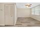 Bedroom with wood floors, white walls, a ceiling fan, and a closet at 4885 1St Ne St # 308, St Petersburg, FL 33703
