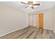 Bright bedroom with wood floors, ceiling fan, closet, and double doors for ample natural light at 4885 1St Ne St # 308, St Petersburg, FL 33703