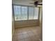 Cozy bedroom with tile floors, blinds, and a ceiling fan at 4885 1St Ne St # 308, St Petersburg, FL 33703
