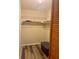 Small closet with wood floor, wire shelving, and a plastic storage container at 4885 1St Ne St # 308, St Petersburg, FL 33703