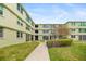 Well-maintained building exterior, showcasing lush landscaping and a welcoming entrance for residents at 4885 1St Ne St # 308, St Petersburg, FL 33703