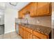 Close up of kitchen sink and counter area featuring granite countertops and a tile backsplash at 4885 1St Ne St # 308, St Petersburg, FL 33703
