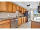 Kitchen with stainless steel appliances, warm wood cabinets, and granite countertops at 4885 1St Ne St # 308, St Petersburg, FL 33703