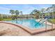 Community pool area with lounge chairs and tropical palm trees at 4885 1St Ne St # 308, St Petersburg, FL 33703