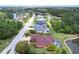 Aerial view of a home nestled in a residential area, featuring a screened-in pool and pond at 5391 90Th Avenue E Cir, Parrish, FL 34219