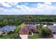 Aerial view of a single-Gathering home with a private pond, mature landscaping, and a three-car garage at 5391 90Th Avenue E Cir, Parrish, FL 34219