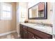 Bathroom vanity with dark wood cabinets, granite counters and a large mirror at 5391 90Th Avenue E Cir, Parrish, FL 34219