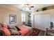 Bright bedroom with a ceiling fan, shuttered window and built-in shelving at 5391 90Th Avenue E Cir, Parrish, FL 34219