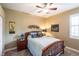Cozy bedroom with a full-sized bed, ceiling fan, and neutral decor at 5391 90Th Avenue E Cir, Parrish, FL 34219