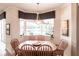 Dining area with wood table and seating adjacent to large windows overlooking outdoor living space at 5391 90Th Avenue E Cir, Parrish, FL 34219