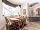 Sunlit dining area features wood table and chairs with a bay window overlooking the backyard at 5391 90Th Avenue E Cir, Parrish, FL 34219