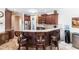 Kitchen bar with dark wood cabinetry, granite countertops, and stainless steel appliances at 5391 90Th Avenue E Cir, Parrish, FL 34219