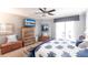 Comfortable main bedroom features wood furniture, ceiling fan, and ensuite bath at 5391 90Th Avenue E Cir, Parrish, FL 34219