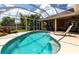 Beautiful screened-in pool area with seating, a lounger and outdoor features at 5391 90Th Avenue E Cir, Parrish, FL 34219