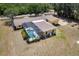 Aerial view of backyard swimming pool with a screened enclosure and lush landscaping at 6217 Goldfinch St, Sarasota, FL 34241