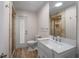 Modern bathroom with a glass-enclosed shower, a large mirror, and a single sink vanity at 6217 Goldfinch St, Sarasota, FL 34241
