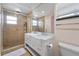 Bathroom featuring a double sink vanity, spacious shower, and a large mirror at 6217 Goldfinch St, Sarasota, FL 34241