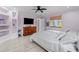 Bright bedroom with ceiling fan, natural light, a TV, and built-in shelving for storage at 6217 Goldfinch St, Sarasota, FL 34241