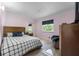 Cozy bedroom with checkered comforter, stylish furniture, and large window at 6217 Goldfinch St, Sarasota, FL 34241