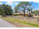 A ranch-style home surrounded by green trees and an authentic wooden fence at 6217 Goldfinch St, Sarasota, FL 34241