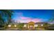 Inviting single-story home featuring a picturesque front yard, lush plants, and a double-door entryway at 6217 Goldfinch St, Sarasota, FL 34241