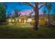 Charming yellow single-story home with manicured lawn, lush landscaping, and inviting double-door entrance at 6217 Goldfinch St, Sarasota, FL 34241