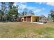 This is a two-car garage featuring brown garage doors, an attached carport, and a well-maintained lawn and landscaping at 6217 Goldfinch St, Sarasota, FL 34241