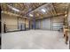 This is a large garage interior with a high ceiling, a car lift, and multiple bay doors at 6217 Goldfinch St, Sarasota, FL 34241