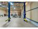 Garage interior featuring car lift, work tables, storage shelves, and bay doors at 6217 Goldfinch St, Sarasota, FL 34241