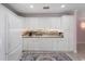 Bright kitchen featuring white cabinetry, modern appliances, and elegant marble countertops and backsplash at 6217 Goldfinch St, Sarasota, FL 34241