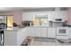 Well-lit kitchen features white cabinetry and modern appliances at 6217 Goldfinch St, Sarasota, FL 34241