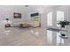 Bright living room featuring tile flooring, white leather seating, and double doors to backyard at 6217 Goldfinch St, Sarasota, FL 34241