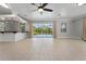 Spacious living room with tiled floors, a bar, and sliding glass doors to pool at 6217 Goldfinch St, Sarasota, FL 34241