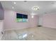 Bright living room with tile flooring, a large window, and recessed lighting at 6217 Goldfinch St, Sarasota, FL 34241