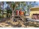 This is a backyard playhouse featuring a deck, stairs, and a red exterior at 6217 Goldfinch St, Sarasota, FL 34241