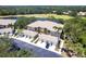 Scenic aerial view of condo community with tile roofs, garages, and lush green landscaping near golf course at 6334 Grand Oak Cir # 202, Bradenton, FL 34203