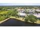 Scenic waterfront condo overlooking a serene lake surrounded by lush greenery and mature trees at 6334 Grand Oak Cir # 202, Bradenton, FL 34203