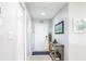 Inviting entryway with coastal decor, including a beach sign, artwork, and a console table with decorative items at 6334 Grand Oak Cir # 202, Bradenton, FL 34203
