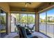Inviting lanai with comfortable seating, ceiling fan, and serene water views, perfect for relaxing at 6334 Grand Oak Cir # 202, Bradenton, FL 34203