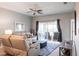 Cozy living room featuring a comfortable sofa, ceiling fan, rug, and sliding glass doors to the patio at 6334 Grand Oak Cir # 202, Bradenton, FL 34203