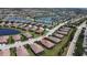 An aerial view of a beautiful suburban neighborhood with tile-roofed homes, lush landscaping, and serene lakes at 6740 Willowshire Way, Bradenton, FL 34212