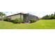 Well-maintained lawn and landscape surrounding the screened-in lanai at 6740 Willowshire Way, Bradenton, FL 34212