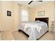 Bright bedroom with a ceiling fan, large window and coastal themed decor at 6740 Willowshire Way, Bradenton, FL 34212