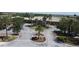 Beautiful clubhouse entrance featuring mature palms, flowers, and a circular drive at 6740 Willowshire Way, Bradenton, FL 34212